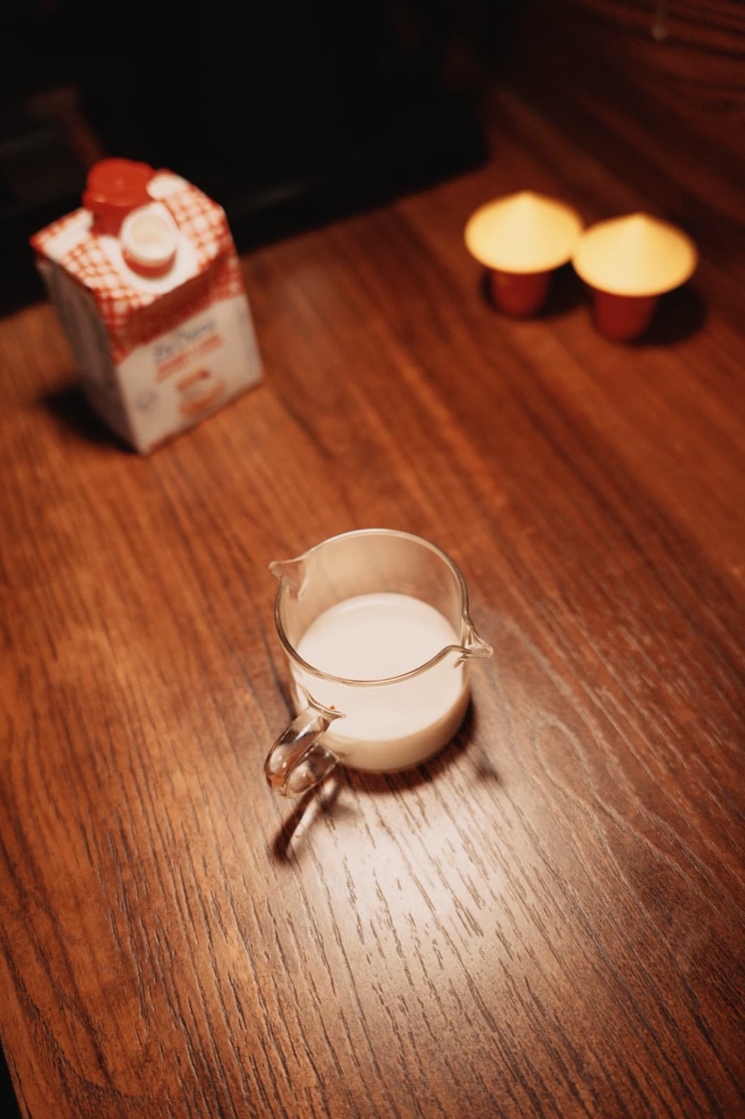 Milk pouring from a glass pitcher, shot from above